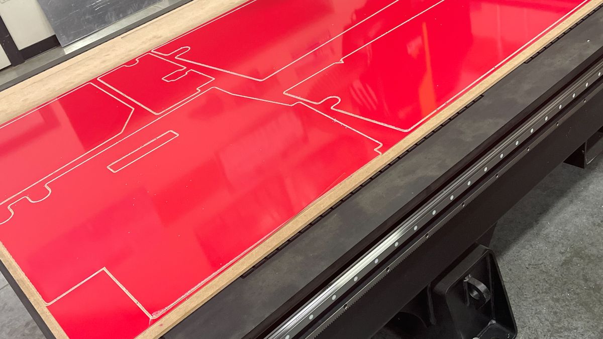 CNC plasma table cutting a sheet, one of the fabrication projects in the shop
