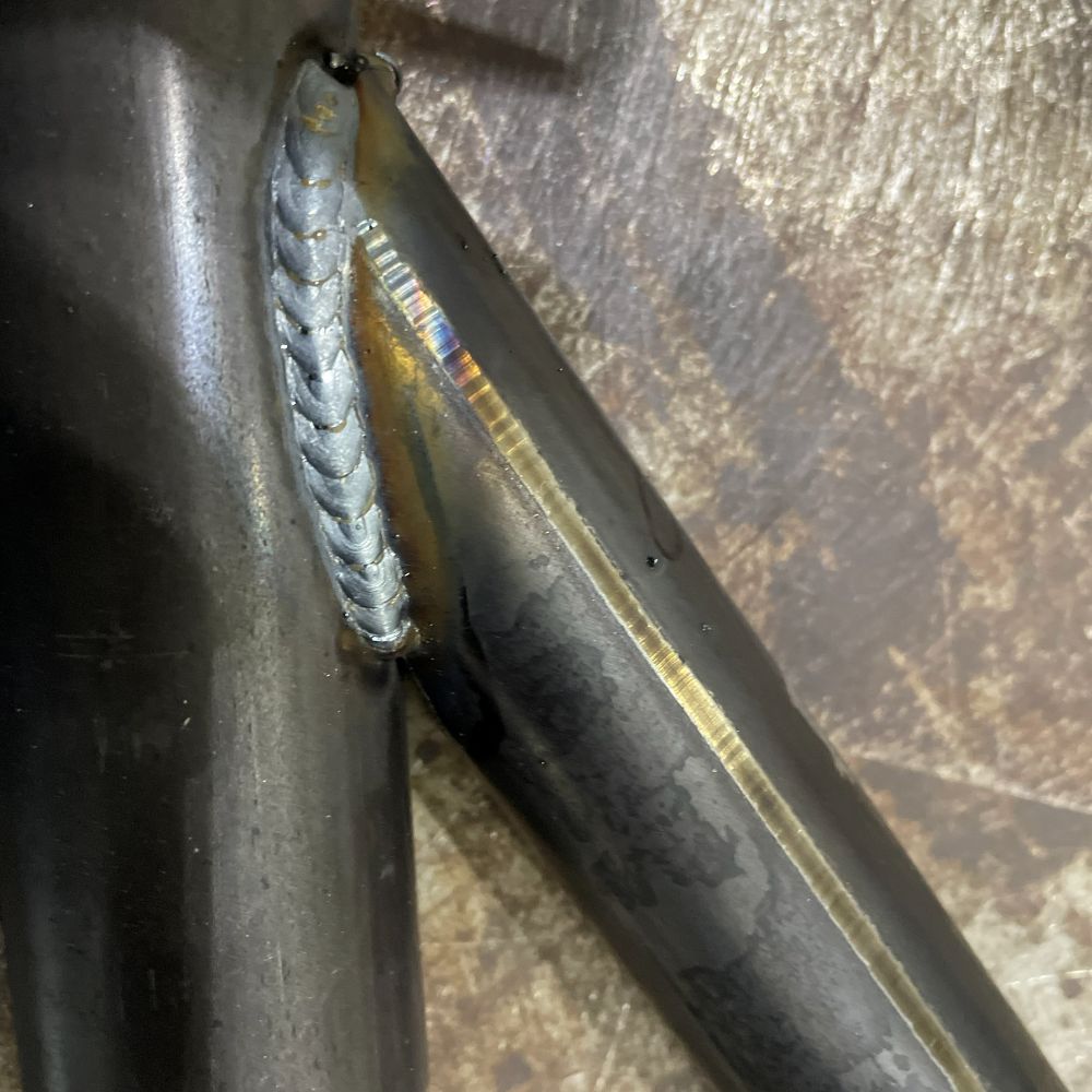Close-up of a welded joint where two tubes meet