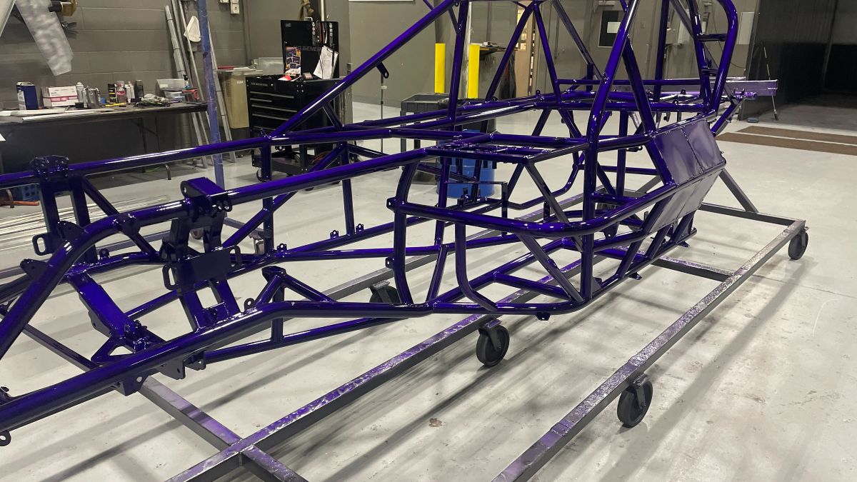 Race chassis finished in purple, on stands