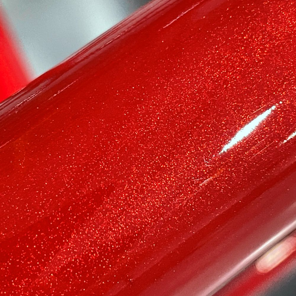 Close-up of a red metallic powder coat