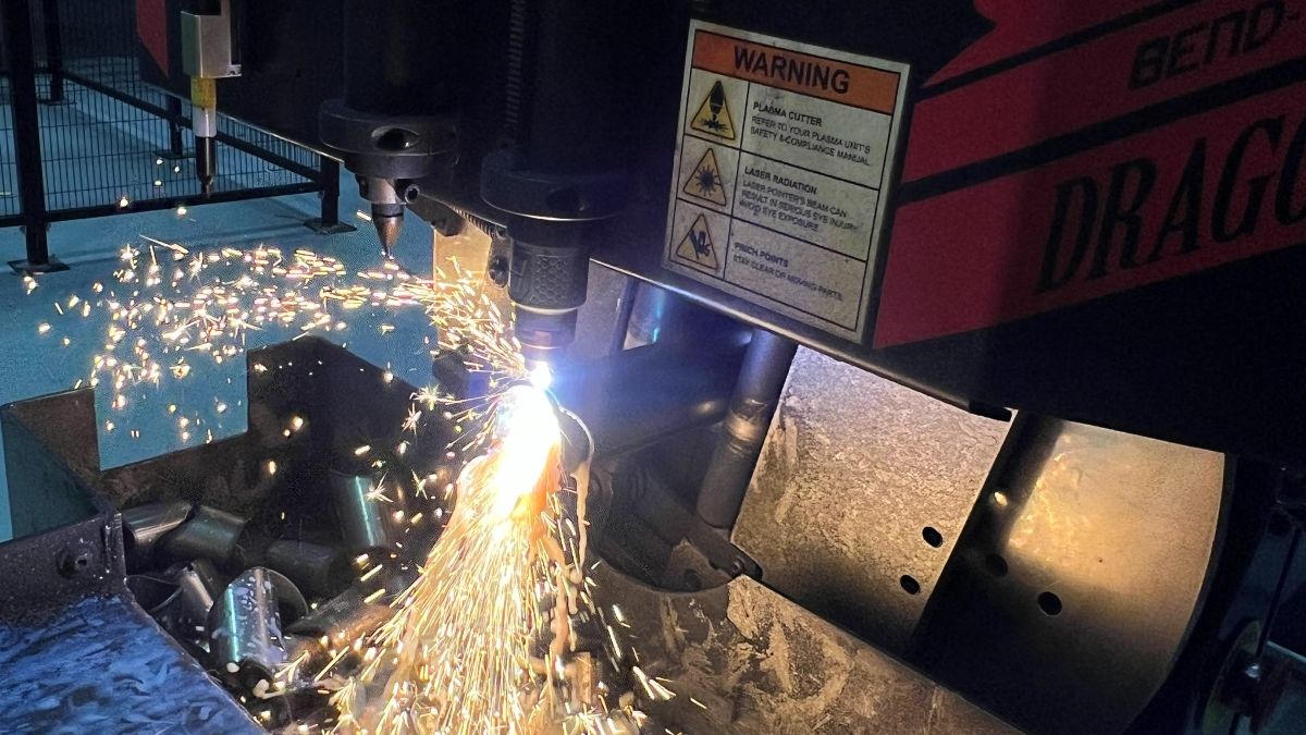 Plasma notcher cutting a tube, sparks off the cut